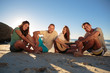 Group of friends sitting on the beach