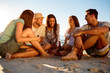 Friends partying on the beach with beers