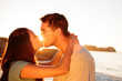 Couple embracing and kissing each other on the beach