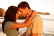 Smiling couple embracing each other on the beach