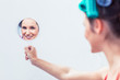 Young woman holding a mirror