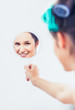 Beautiful woman holding a mirror