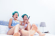 Surprised friends on sofa
