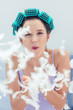 Attractive woman blowing feathers