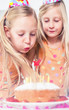Little girl blowing her candles