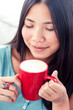 Attractive asian woman drinking coffee