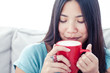 Asian woman drinking coffee