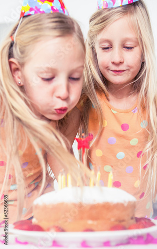 Photo: Little girl blowing her candles Little girl blowing her candles