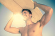 Handsome man holding his surfboard above his head
