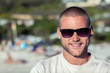 Attractive man wearing sunglasses on the beach