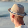 Relaxed man with a hat on the beach