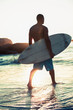 Attractive surfer walking in the sea