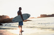 Handsome man holding surfboard