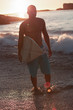 Silhouette of a man holding a surfboard