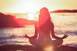 Woman doing yoga on the beach