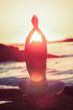 Silhouette of woman doing yoga during the sunset