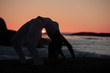 Silhouette of a woman doing crab yoga pose