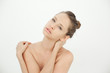 Beautiful young woman standing topless