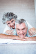 Mature couple cuddling and lying together