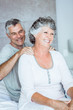 Mature man giving a shoulders massage to his wife