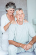 Mature woman giving a shoulder massage to her husband