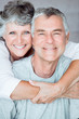 Cheerful mature woman embracing her husband