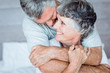 Mature man cuddling his wife