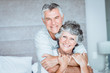 Retired couple posing together on the bed