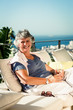 Cheerful mature woman relaxing outdoors