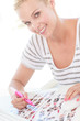 Cheerful photo editor working on a contact sheet