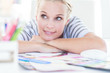 Cheerful designer posing on her desk