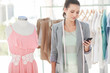 Cheerful fashion designer text messaging