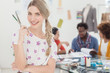 Attractive designer posing and holding scissors