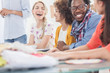 Cheerful group of fashion designers discussing together
