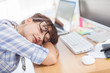 Overworked designer sleeping on her desk