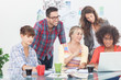 Team of creative designers working on a laptop