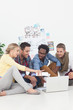 Young team of creative designers sat on the floor