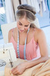Fashion designer sewing a textile