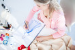 Blonde fashion designer drawing clothes