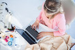 Blonde fashion designer working on her laptop