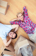 Couple lying on the wooden floor