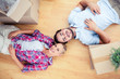 Happy couple lying on the wooden floor