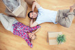 Pretty couple lying on the wooden floor