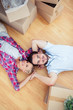 Young couple lying on the wooden floor