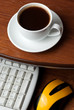 Coffee on computer desk