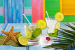 Cuban Mojito cocktail in tropical blue wood flowers and starfish