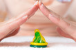 Womans hands doing roof above condom