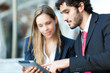 Two business people looking at a tablet