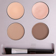 Set of beige eyeshadows and applicator brush