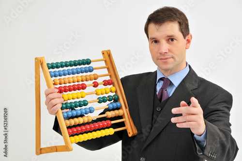 Photo: Businessman with abacus. Businessman with abacus.